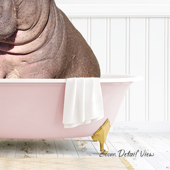 A large brown hippopotamus is sitting in a pink bathtub, with a white towel and gold bathtub leg visible.