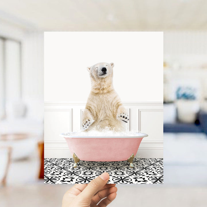 A polar bear sitting in a pink bathtub filled with bubbles, surrounded by a black and white patterned floor.