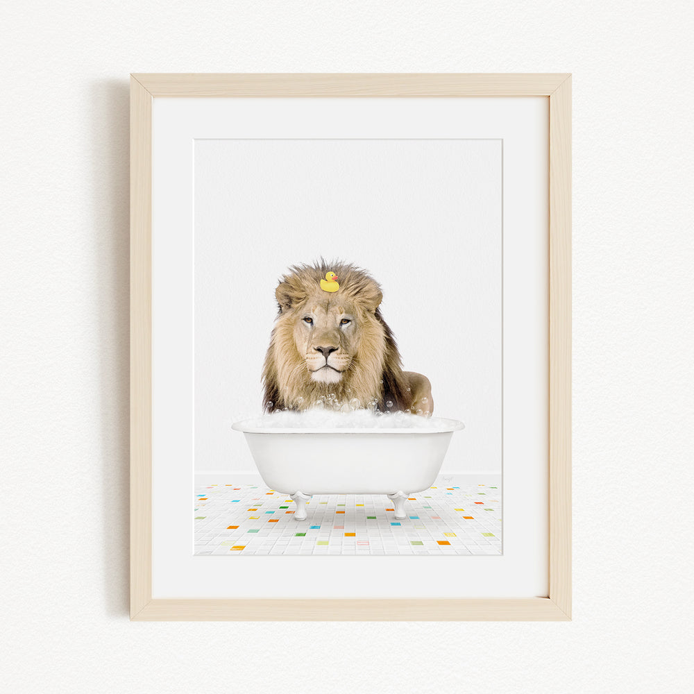 A lion sitting in a white bathtub filled with bubbles, with a yellow rubber duck floating on the water.
