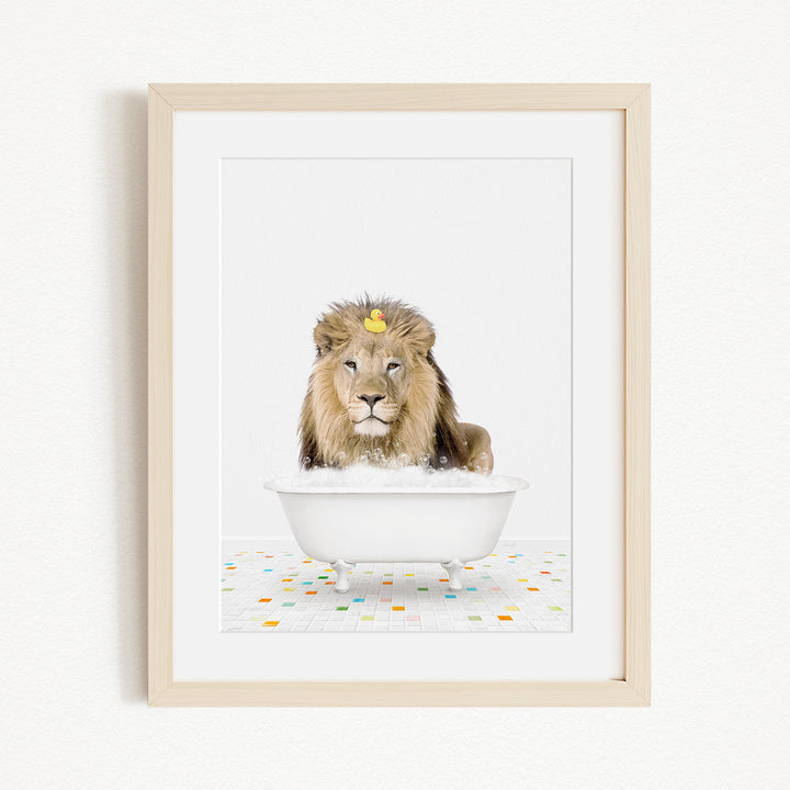 A lion sitting in a white bathtub filled with bubbles, with a yellow rubber duck floating on the water.