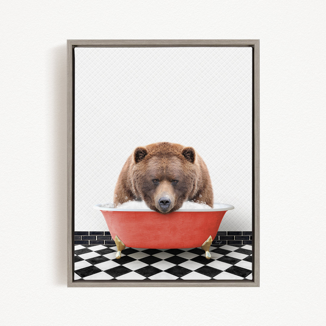 A brown bear is sitting in a red bathtub, appearing to be enjoying a relaxing bath.