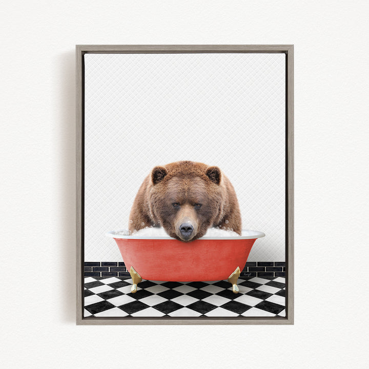 A brown bear is sitting in a red bathtub, appearing to be enjoying a relaxing bath.