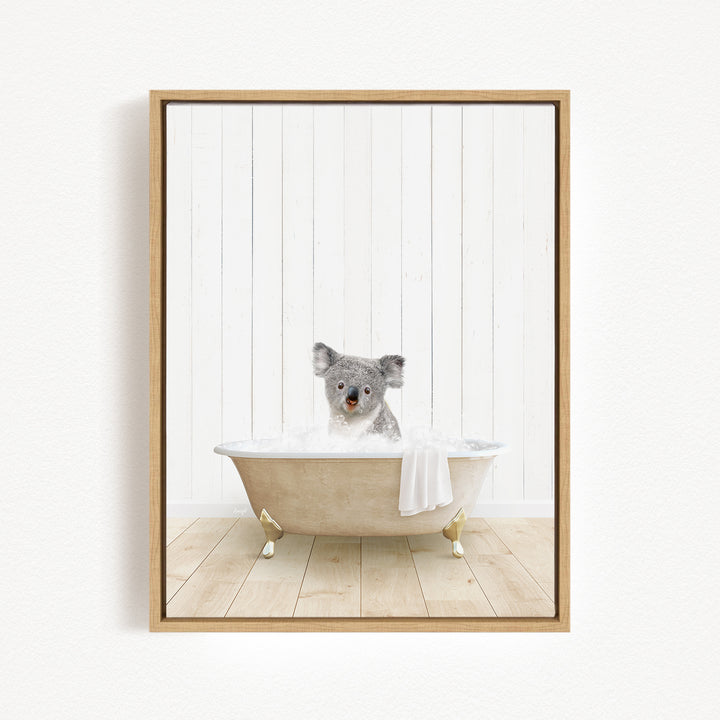 A koala bear sitting in a bathtub filled with water, surrounded by a white wooden wall.