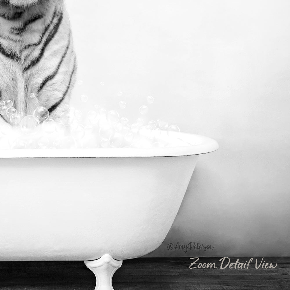 A black and white image of a cat standing in a bathtub filled with bubbles, with the cat's front paws in the water.