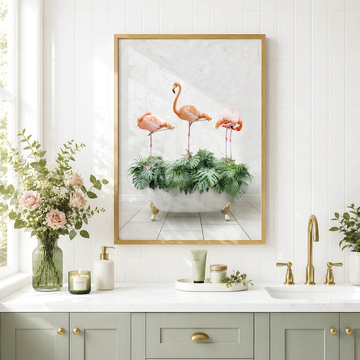 a bathroom with a framed picture of three flamingos standing on a green plant in a bathtub, surrounded by greenery. The bathroom has a white countertop, a sink, and a vase with flowers. The overall color scheme is predominantly white and green, creating a serene and natural atmosphere.