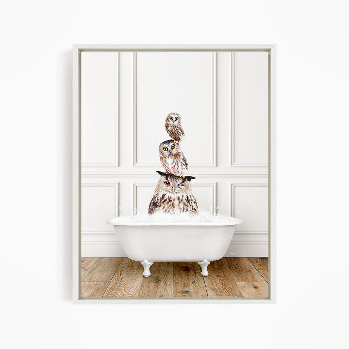 A white bathtub filled with water, with three owls sitting on top of it.