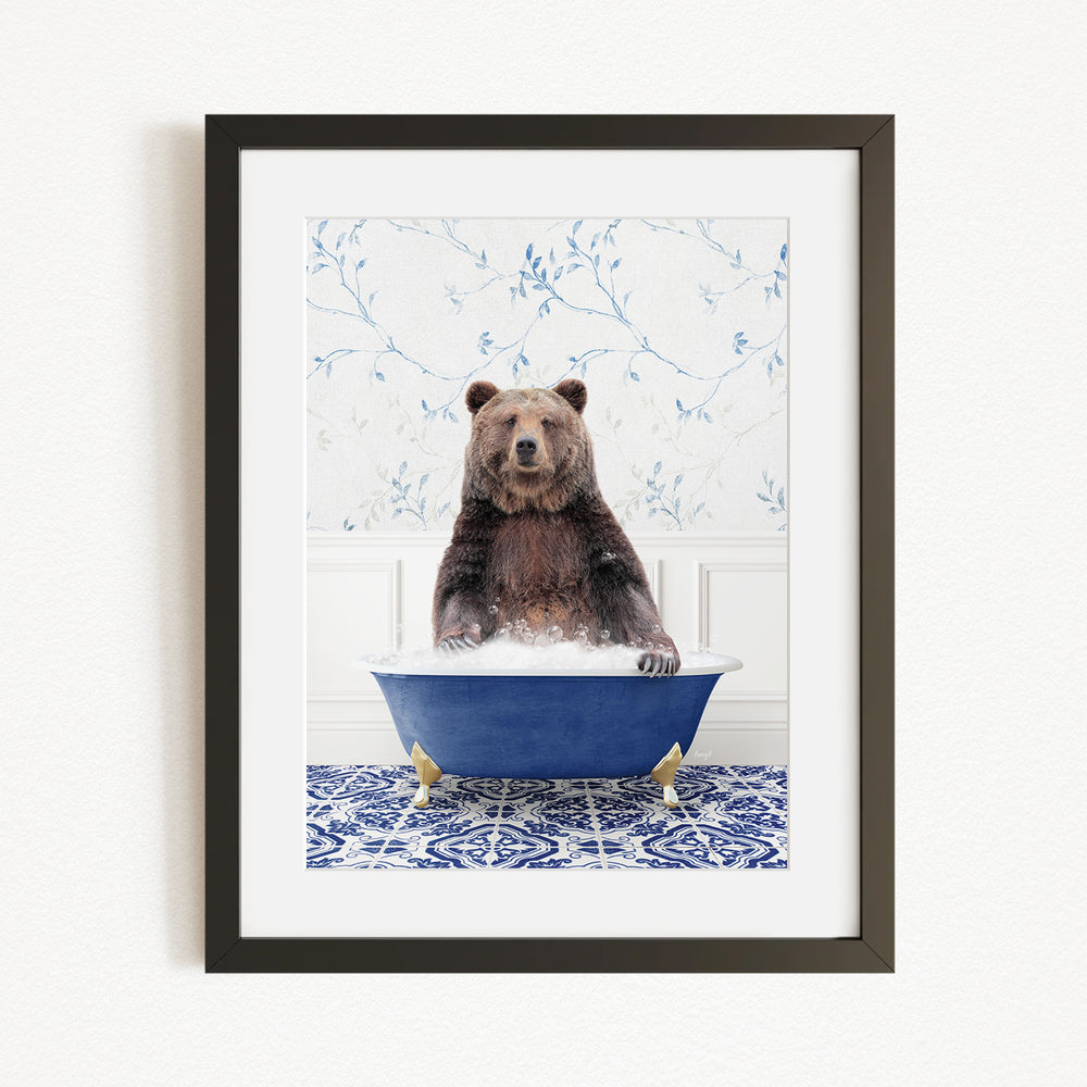 A brown bear sitting in a blue bathtub filled with water, surrounded by a blue and white floral patterned wall.