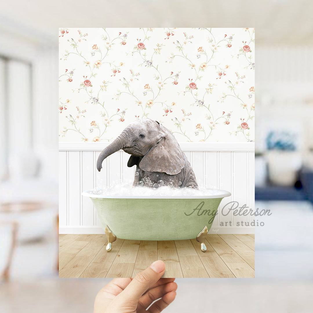 a person holding up a picture of an elephant in a bathtub