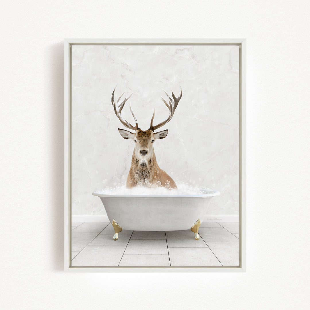 A deer with large antlers is sitting in a white bathtub filled with water, creating a whimsical and unexpected scene.