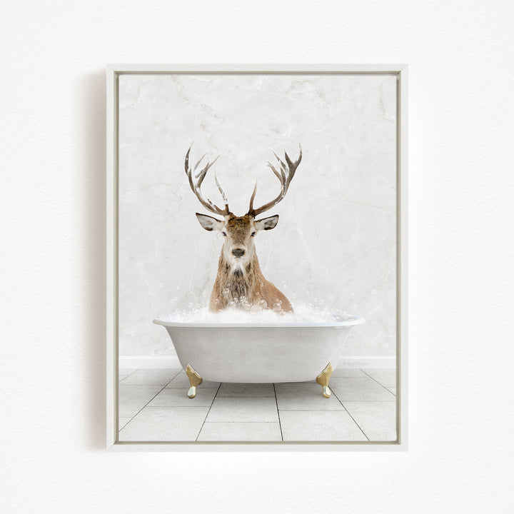 A deer with large antlers is sitting in a white bathtub filled with water, creating a whimsical and unexpected scene.