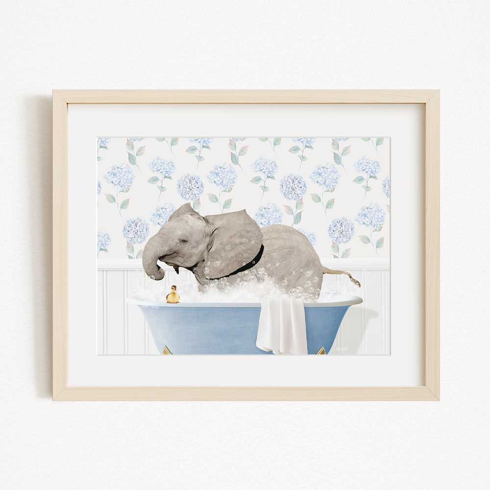 A gray elephant is sitting in a blue bathtub filled with water, surrounded by a floral pattern on the wall behind it.