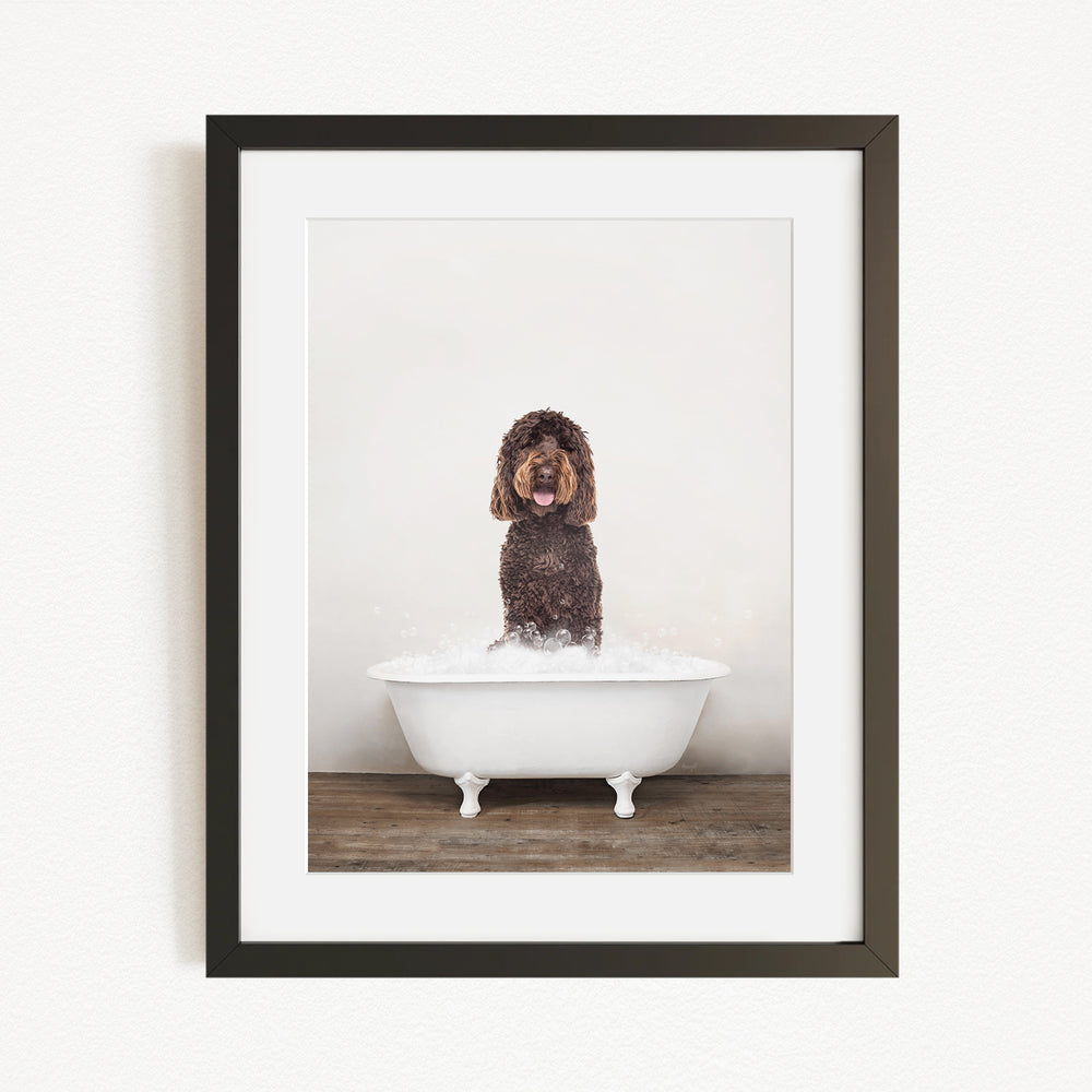 A brown dog sitting in a white bathtub filled with water, with its tongue out, creating a playful and humorous scene.