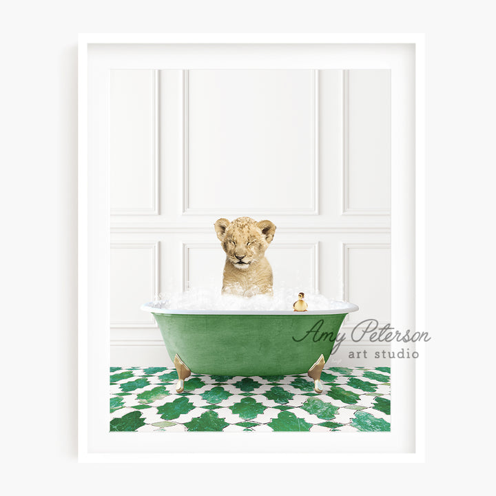 a baby lion sitting in a green bath tub