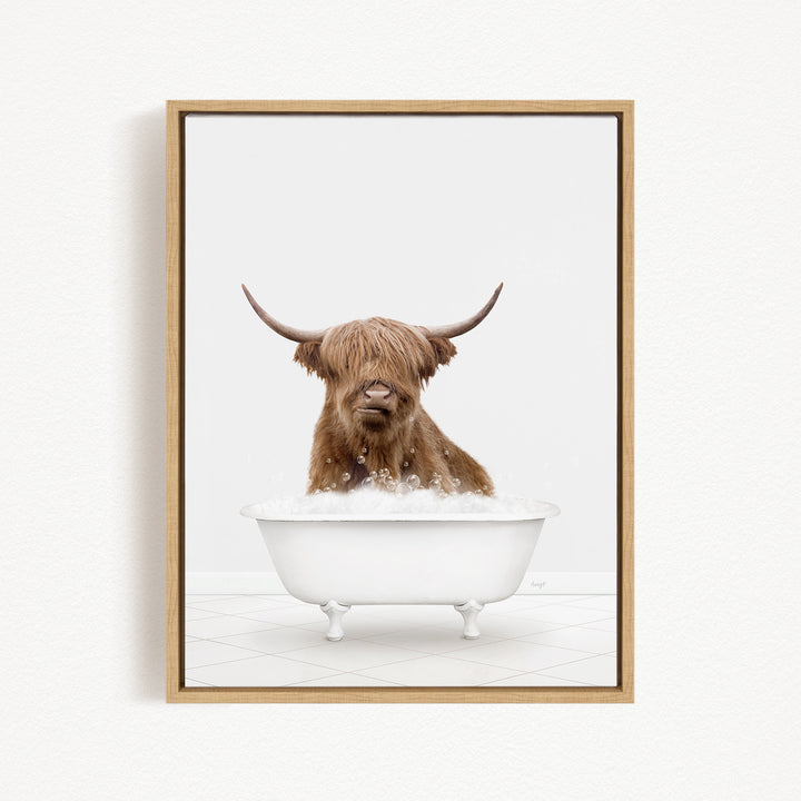 A brown cow with long horns is sitting in a white bathtub filled with water, creating a whimsical and playful scene.