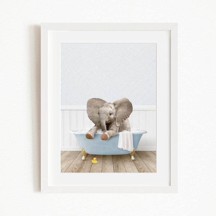 A baby elephant sitting in a blue bathtub, surrounded by yellow rubber duckies.