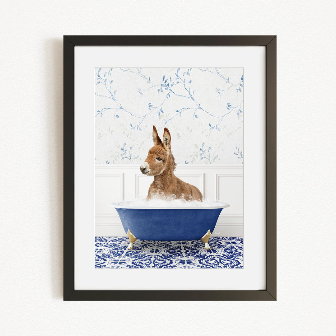 A donkey is sitting in a blue bathtub filled with bubbles, surrounded by a blue and white patterned rug and a white wall with blue floral wallpaper.