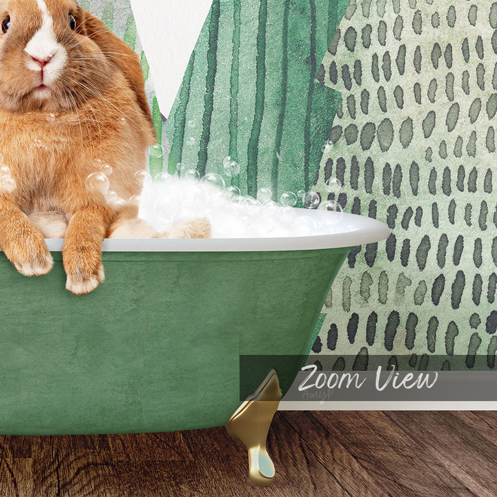 A fluffy orange rabbit sitting in a green bathtub filled with bubbles, with a patterned wall in the background.