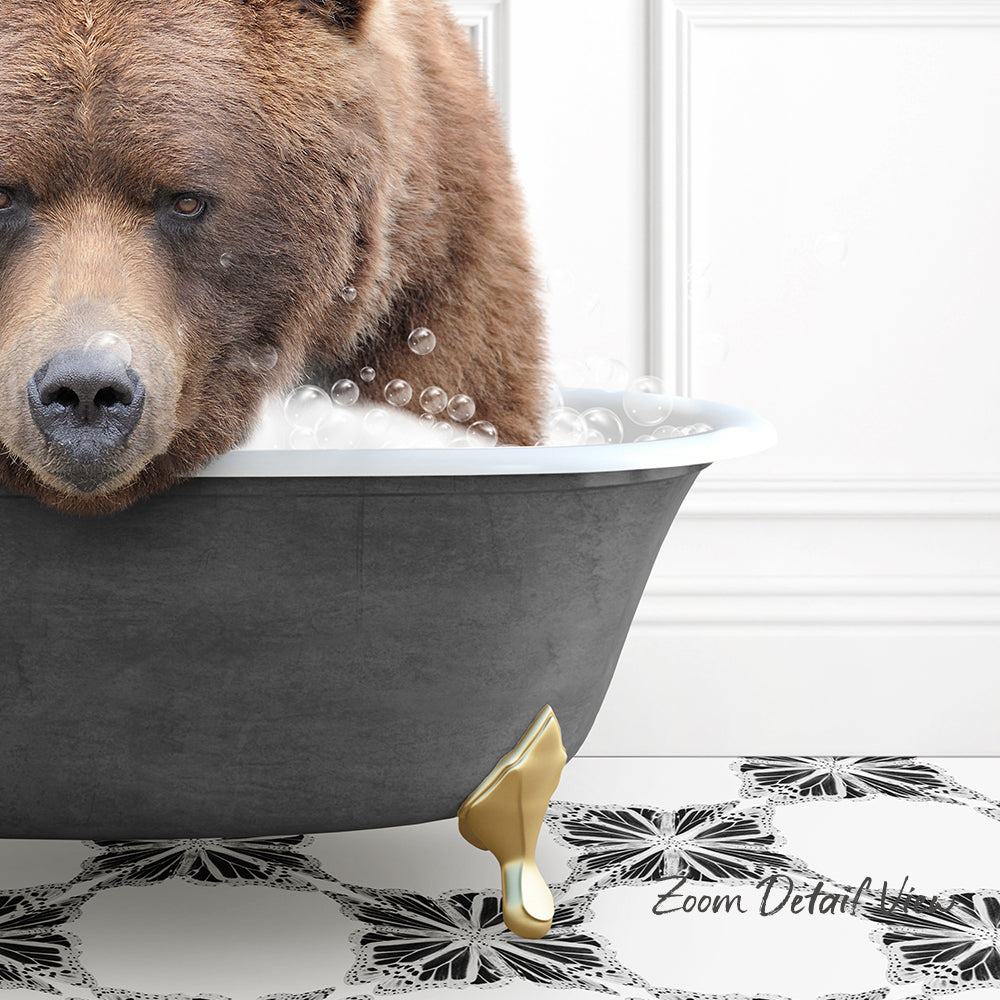 A large brown bear is sitting in a bathtub filled with bubbles, appearing to enjoy a relaxing bath.