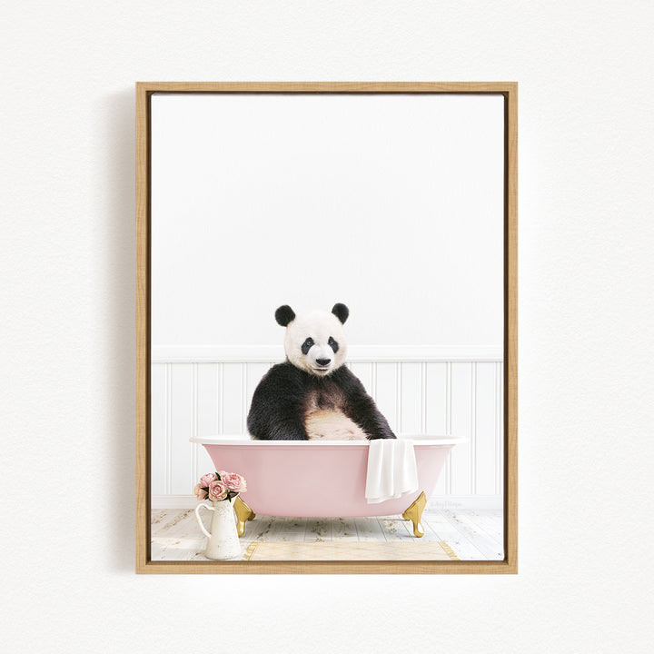 A panda bear sitting in a pink bathtub, surrounded by flowers and a vase.