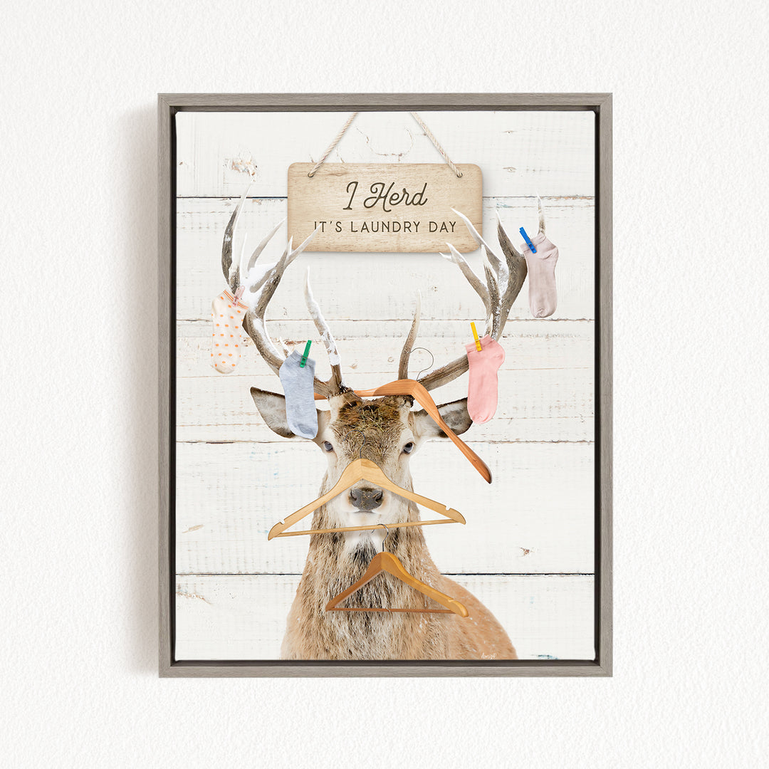 A deer with antlers wearing clothes and socks, with a sign above that says "It's laundry day".