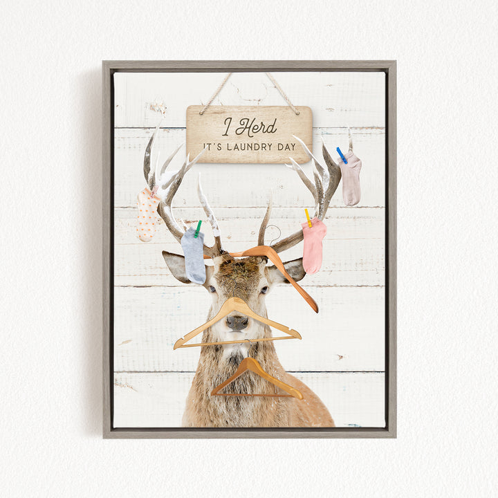 A deer with antlers wearing clothes and socks, with a sign above that says "It's laundry day".