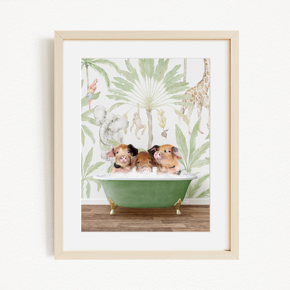 A framed print depicting three pigs sitting in a green bathtub, surrounded by a tropical jungle wallpaper.