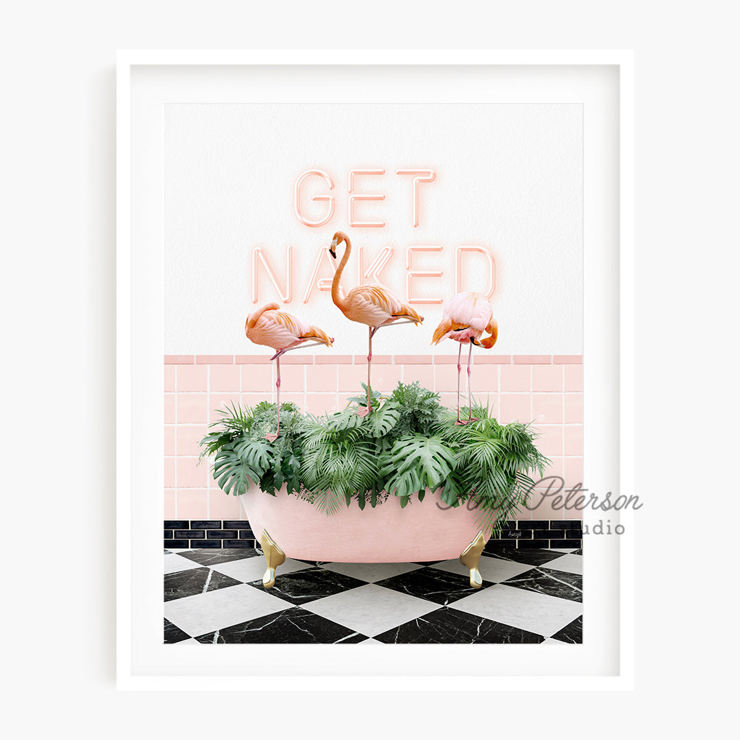 a pink bathtub with three flamingos in it