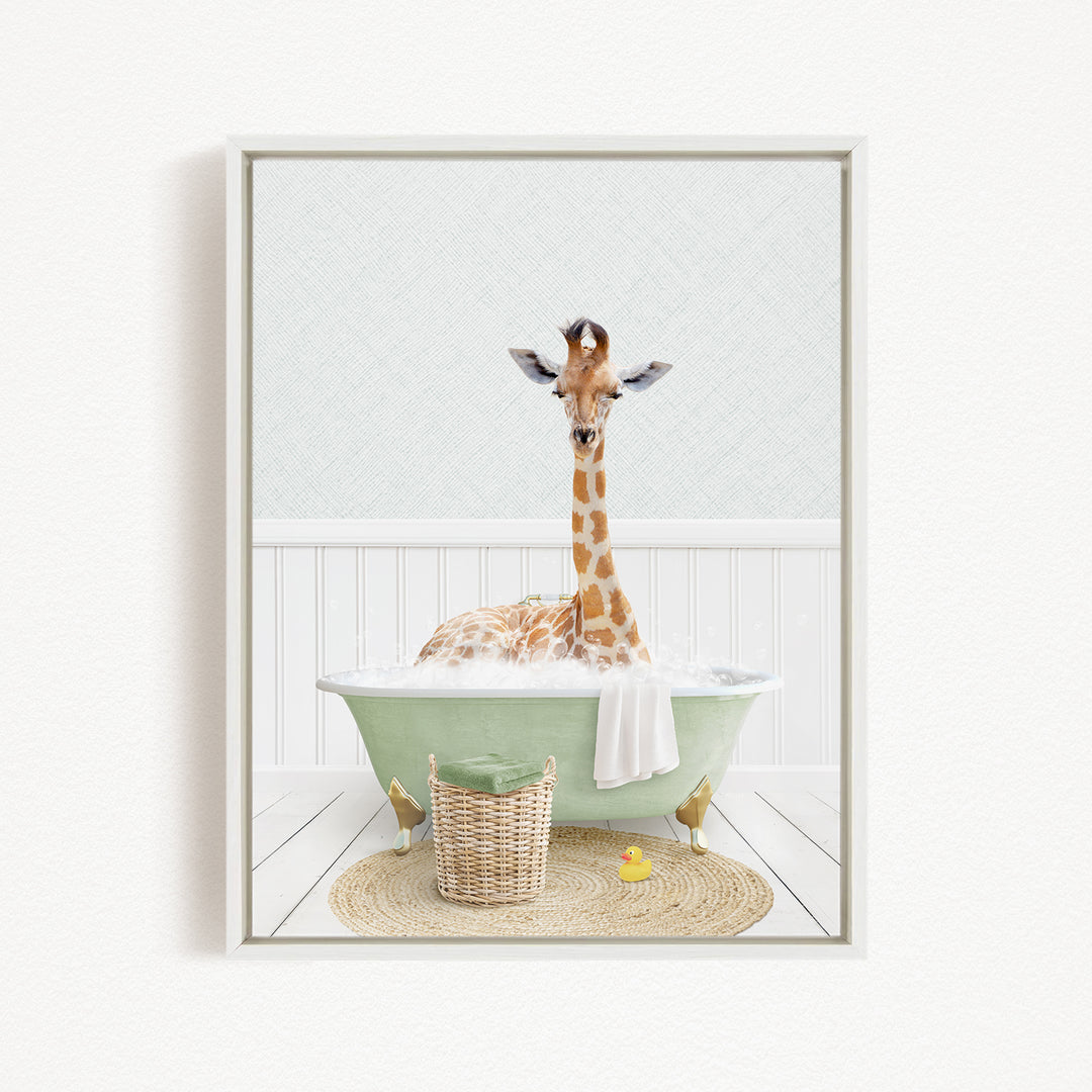 A giraffe sitting in a green bathtub filled with bubbles, surrounded by a basket of toys and a yellow rubber duck.