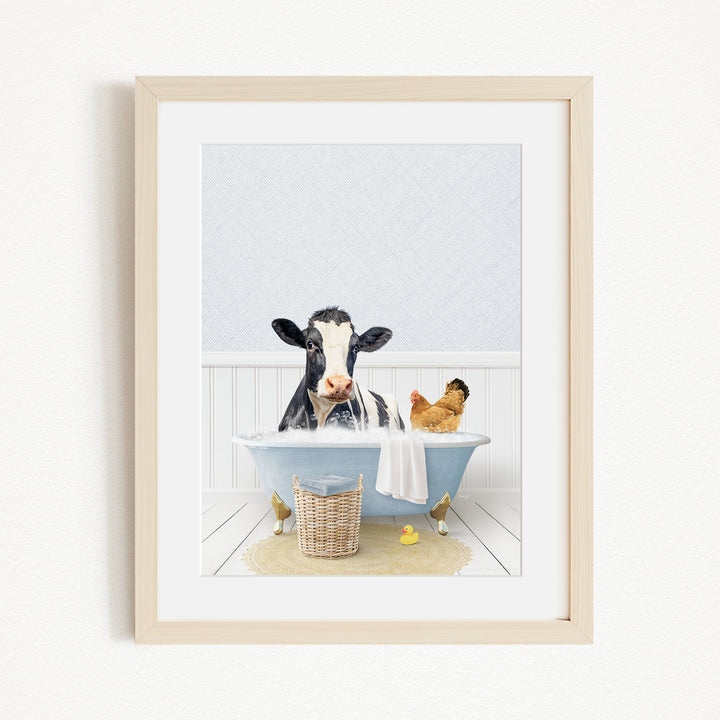 A black and white cow is sitting in a blue bathtub, surrounded by a chicken and a duck, creating a whimsical and playful scene.
