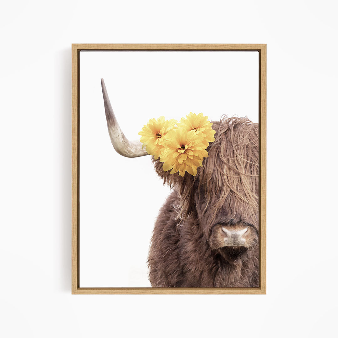 A close-up of a brown cow with large horns, adorned with yellow flowers on its head.