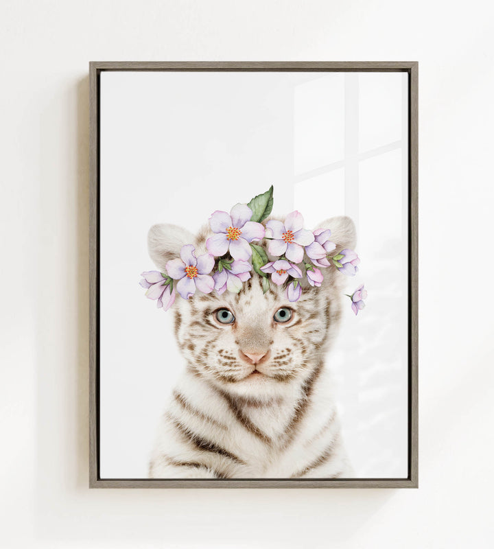 A young tiger cub wearing a floral headpiece with purple flowers.