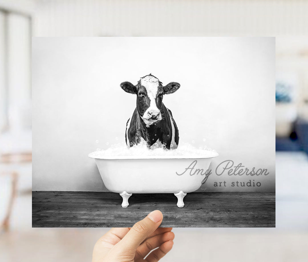 a black and white photo of a cow in a bathtub