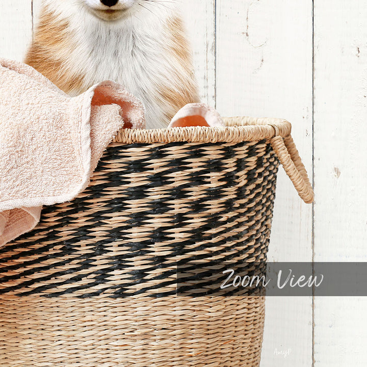 A cat sitting in a woven basket, with a towel draped over its back.