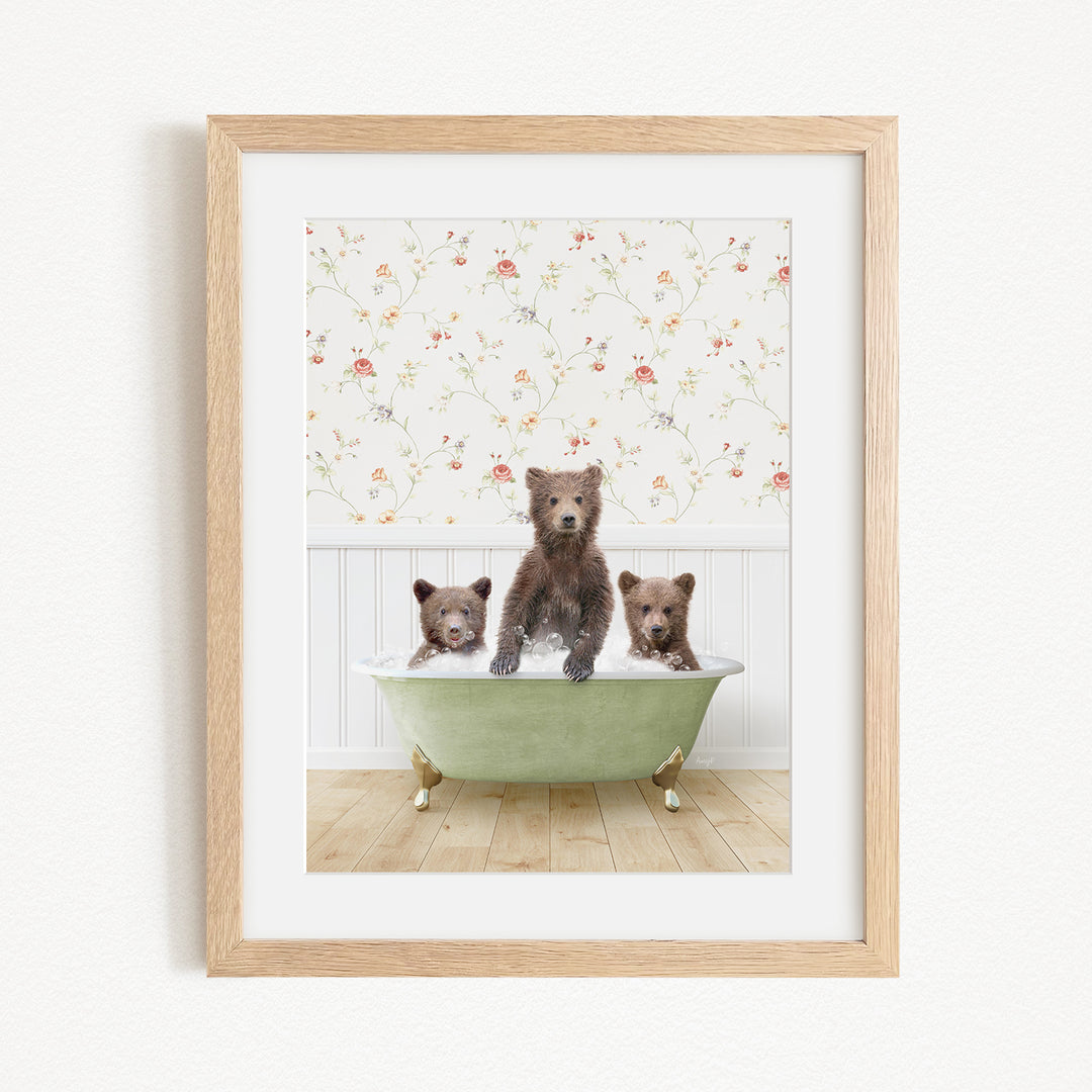 Three adorable brown bears sitting in a green bathtub, with a floral wallpaper in the background.