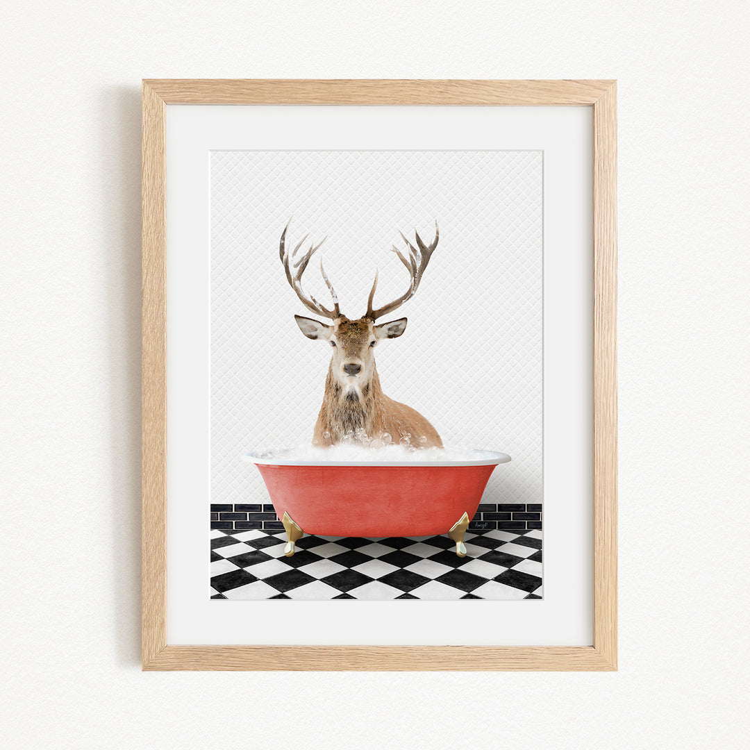 A deer with large antlers is sitting in a red bathtub, surrounded by a black and white checkered floor.