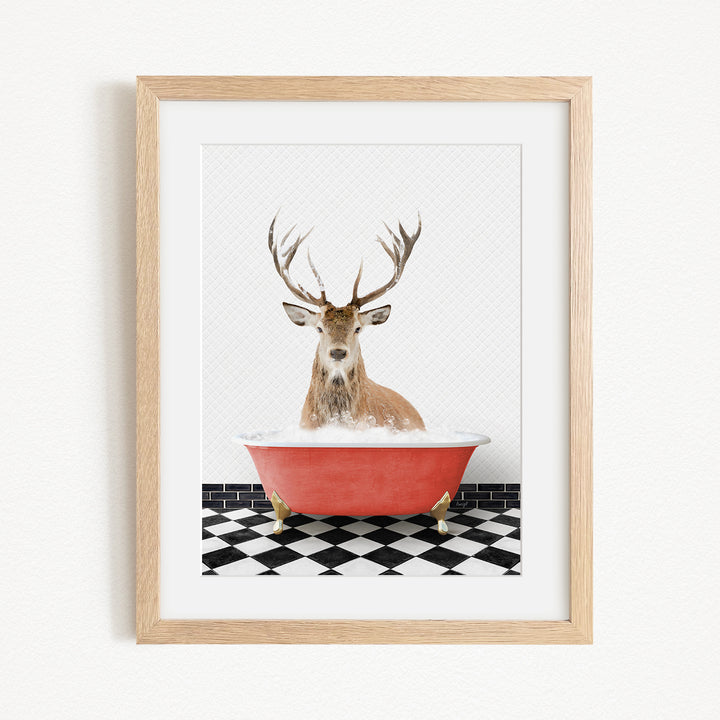 A deer with large antlers is sitting in a red bathtub, surrounded by a black and white checkered floor.
