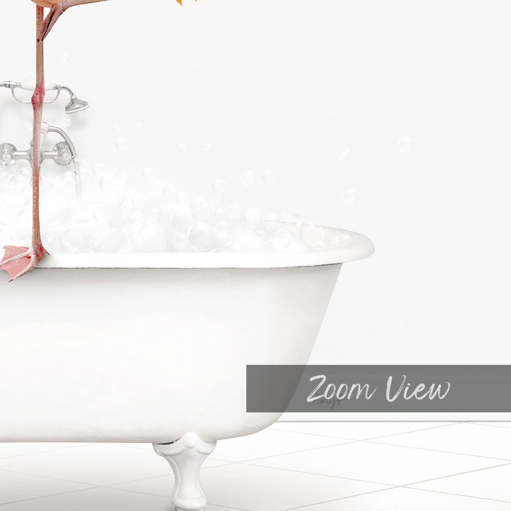 A white claw-foot bathtub filled with bubbles, with a pink object hanging from the side.