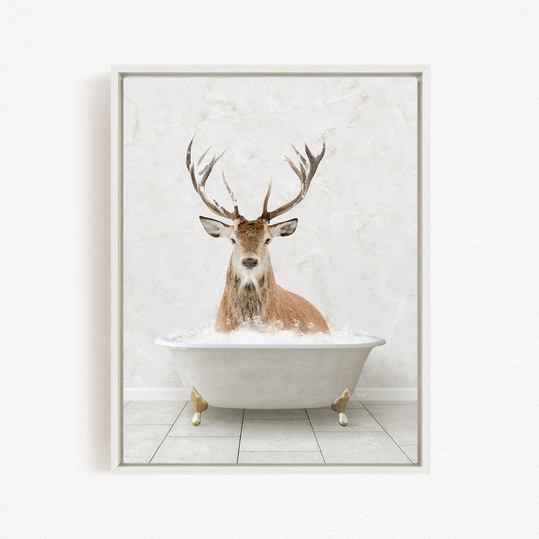 A deer with large antlers is sitting in a white bathtub filled with water, creating a whimsical and unexpected scene.