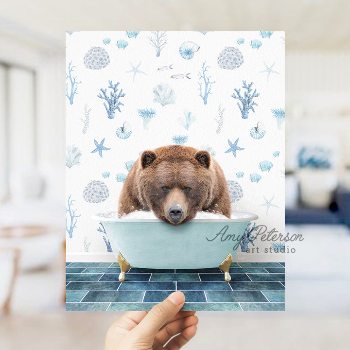 a hand holding up a card with a bear in a bathtub