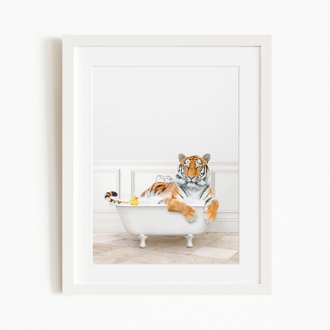 A tiger is sitting in a white bathtub, surrounded by rubber ducks.