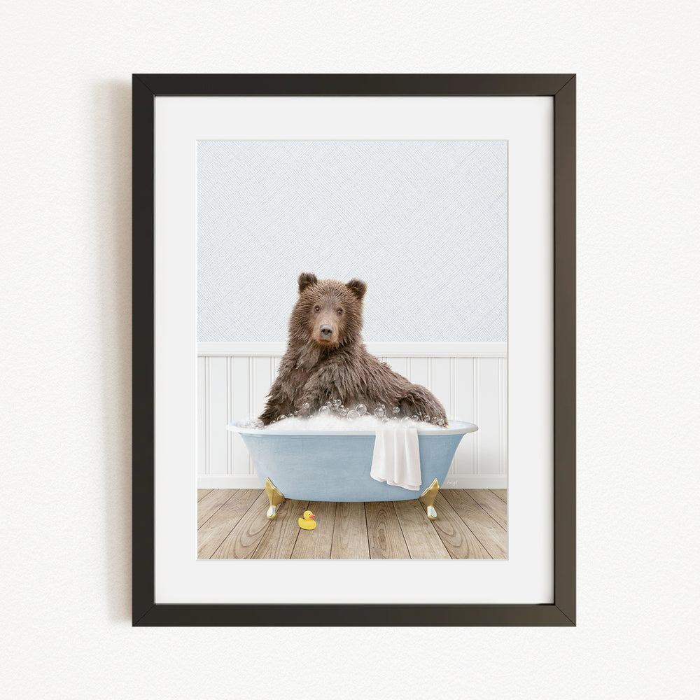 A brown bear sitting in a blue bathtub filled with water, surrounded by yellow rubber duckies.