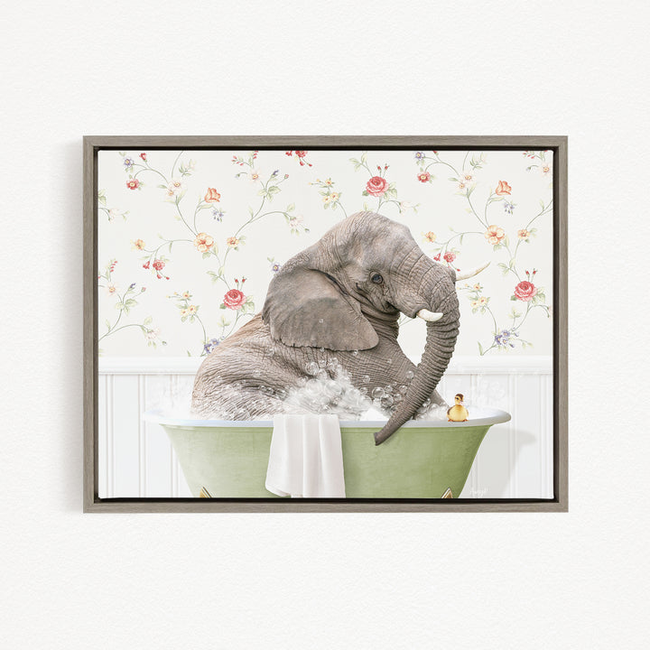 A gray elephant is sitting in a green bathtub, surrounded by a floral patterned wall.