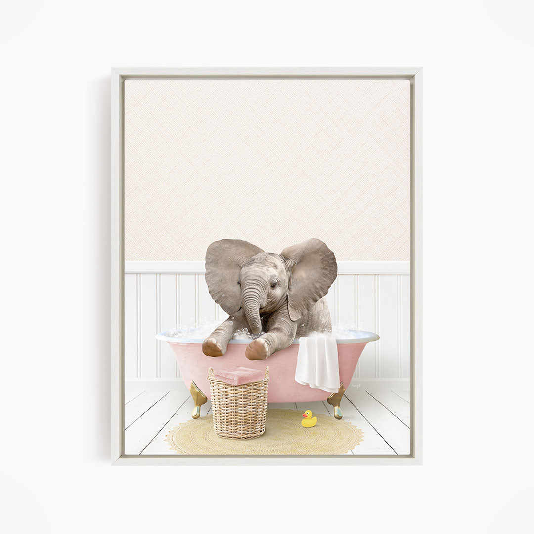 A baby elephant sitting in a pink bathtub, surrounded by a yellow rubber duck and a basket.
