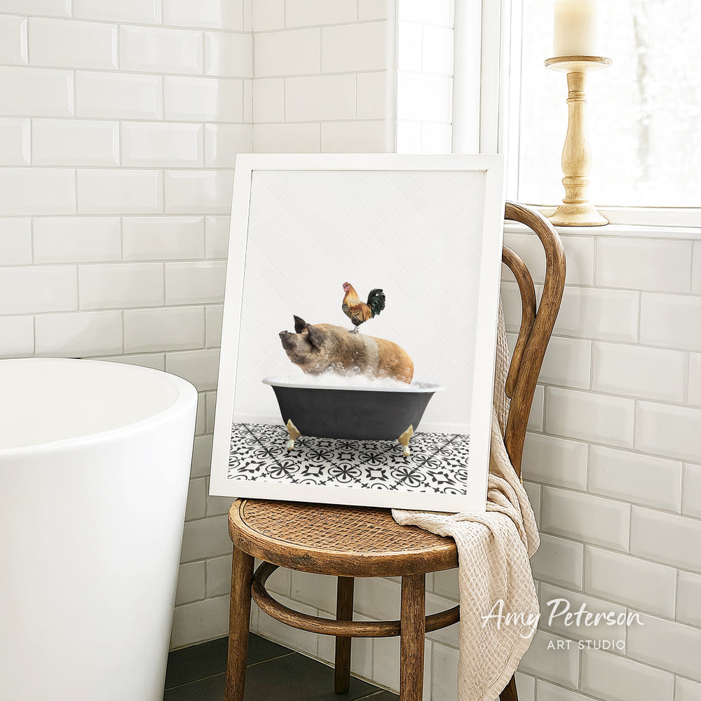 A framed image of a pig sitting in a bathtub, with a rooster perched on its back, is displayed on a wooden chair in a bathroom setting.