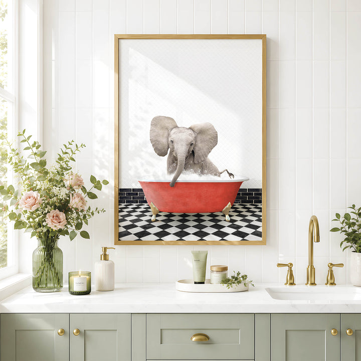 a bathroom scene with a framed picture of an elephant sitting in a red bathtub, surrounded by flowers and greenery.
