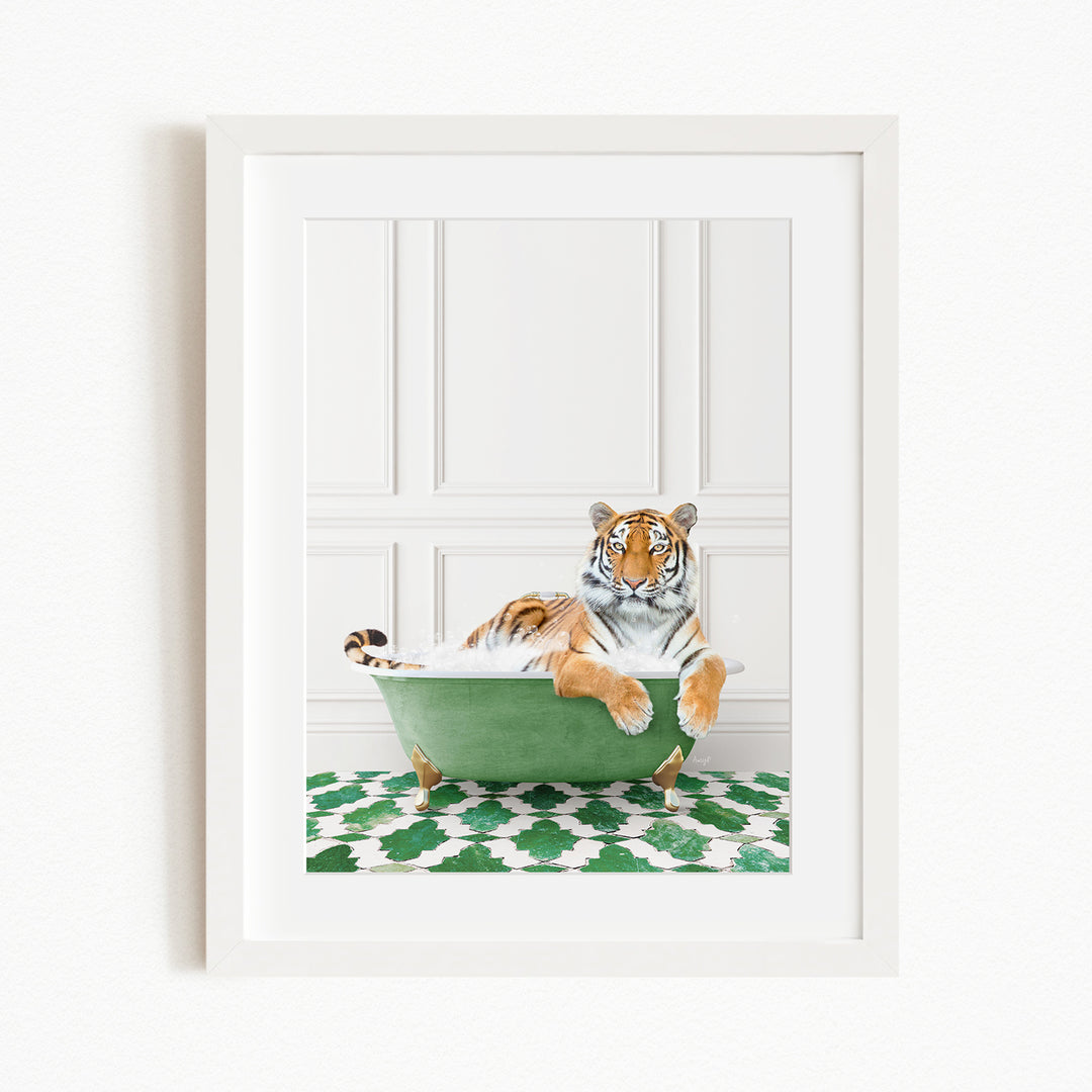 A tiger is sitting in a green bathtub, surrounded by a patterned green and white rug.