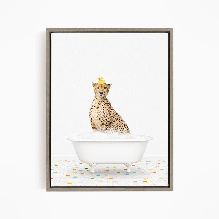 A cheetah sitting in a white bathtub filled with bubbles, wearing a yellow rubber duck hat.
