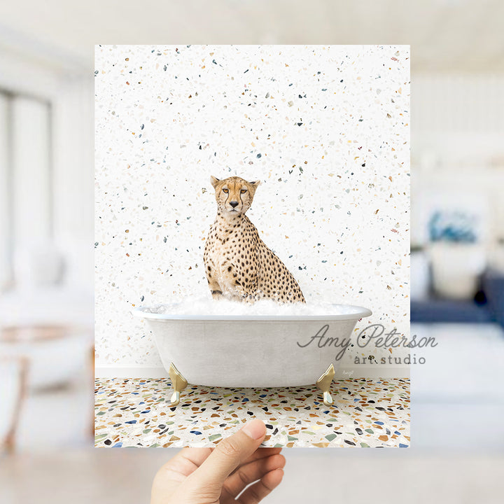 a hand holding a card with a picture of a cheetah in a bath