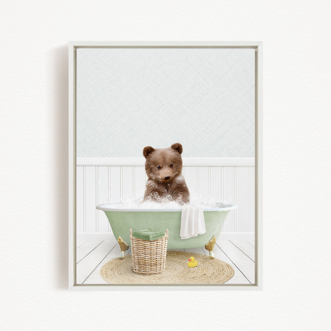 A brown bear sitting in a green bathtub filled with bubbles, surrounded by a yellow rubber duck and a woven basket.