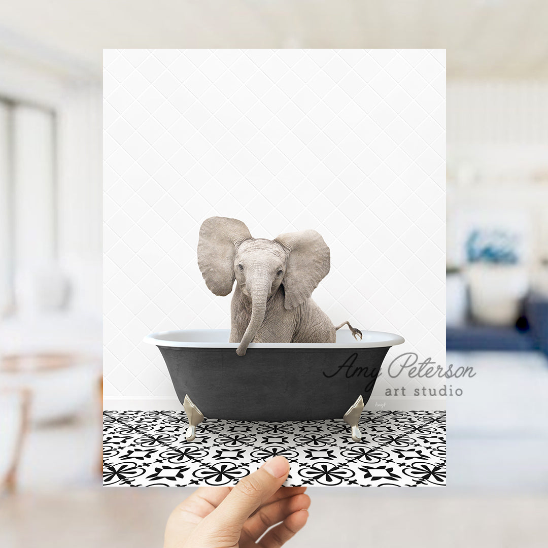 a person holding up a card with an elephant in a bathtub